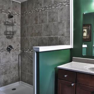 A modern bathroom featuring a tiled shower and a vanity with a mirror.