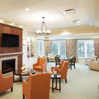 A modern living room with a fireplace and comfortable seating.