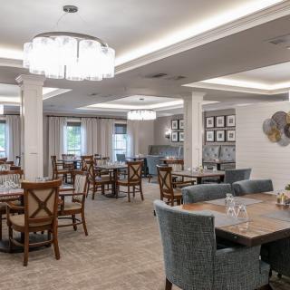 A well-lit dining room with elegant furniture and decor.