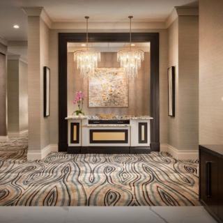 Elegant hotel lobby with luxurious decor and chandeliers.