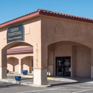 A storefront with an arched entrance on a sunny day.