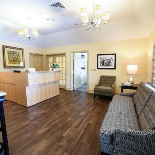 A cozy and well-lit reception area with comfortable seating and modern decor.