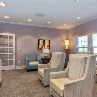 A cozy lounge area with comfortable chairs and warm lighting.