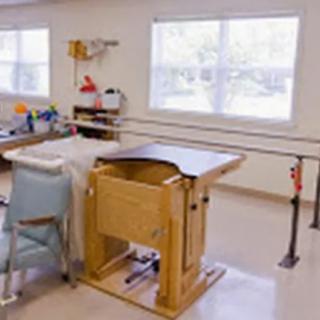 A physical therapy room equipped with rehabilitation tools and exercise equipment.