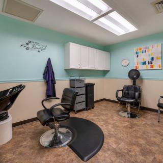 Interior view of a hair salon with styling chairs and equipment.