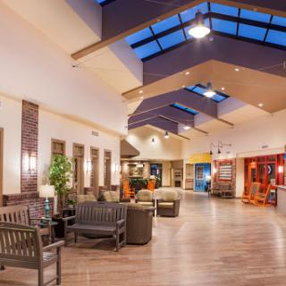 A spacious and welcoming lobby featuring modern seating and natural lighting.