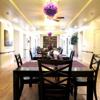 A modern dining area with elegant furniture and decorative lighting.