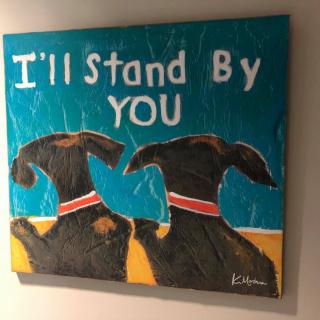 A colorful painting of two dogs with the phrase 'I'll Stand By You'.