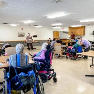 Elderly individuals in a nursing home participating in a group activity.
