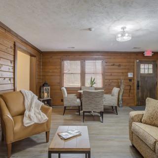 A cozy living room featuring wood paneling and comfortable seating.