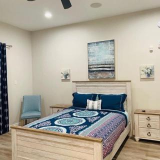 A cozy bedroom with a stylish bed, elegant decor, and soft lighting.