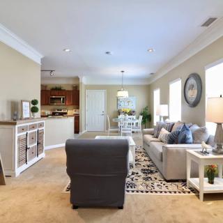 A cozy, well-decorated living room with comfortable seating and stylish decor.