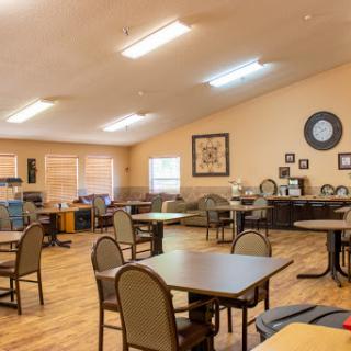 A spacious dining area with tables and chairs set up for gatherings.