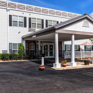 A front entrance of a building with columns and a covered porch.
