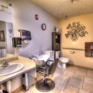 A well-lit modern bathroom featuring essential amenities and decorative elements.