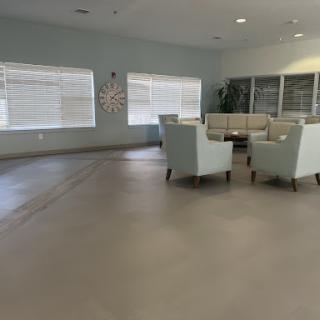 A cozy and modern lounge area with comfortable seating, softly lit by natural light.