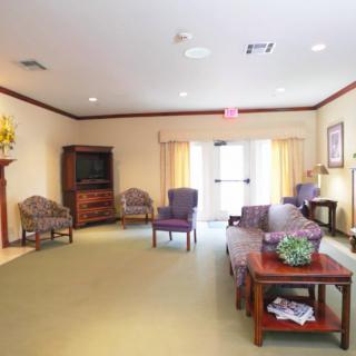 A cozy living room with comfortable chairs, a coffee table, and a television.