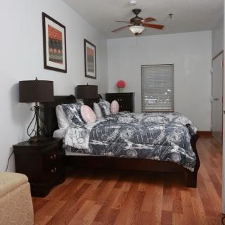 A cozy bedroom with a large bed, nightstands, and modern decor.