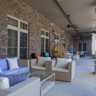 A cozy outdoor patio with comfortable seating and stylish decor.