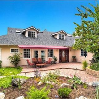 A charming suburban house with a neatly landscaped front yard and inviting entrance.