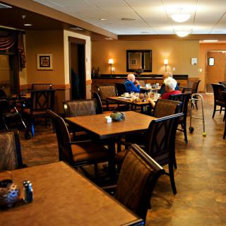 A cozy dining area where senior individuals are seated and socializing.