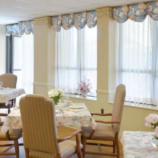 A cozy dining area with elegant decor and table settings.