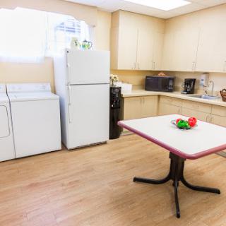 A spacious kitchen area featuring modern appliances and a dining table.
