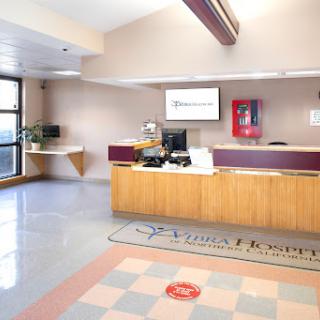 A modern reception area with a desk, computer, and welcoming decor.