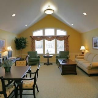 A cozy living room with comfortable seating and large windows.