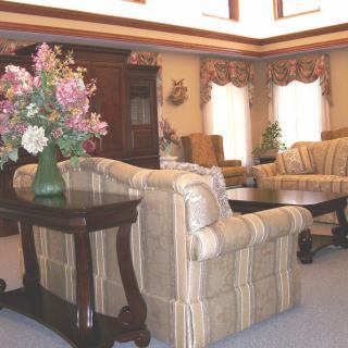 A traditional living room with classic furniture and floral decor.