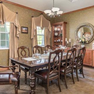 A traditional dining room with elegant furniture and decor.