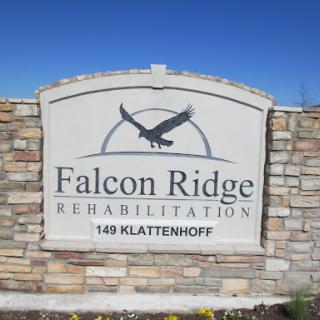 Welcome sign for Falcon Ridge Rehabilitation, featuring a stone design and an eagle emblem.
