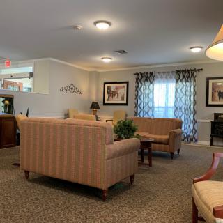 A cozy living room with sofas, a coffee table, and warm lighting.