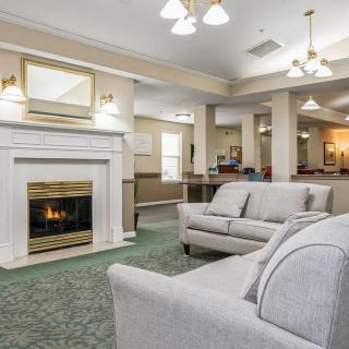 A cozy living room with a fireplace and comfortable seating.