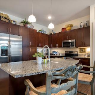 A contemporary kitchen featuring elegant granite countertops and stainless steel appliances, perfect for cooking and entertaining.