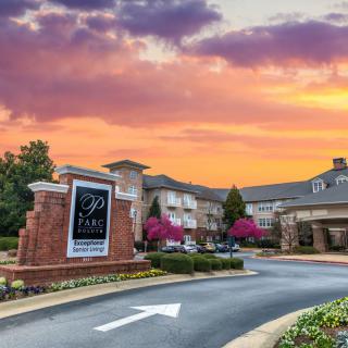 A picturesque view of a hotel entrance at sunset.