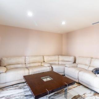 A modern living room with a beige corner sofa and a wooden coffee table.