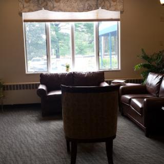 A cozy living room setup with comfortable seating and a view out the window.