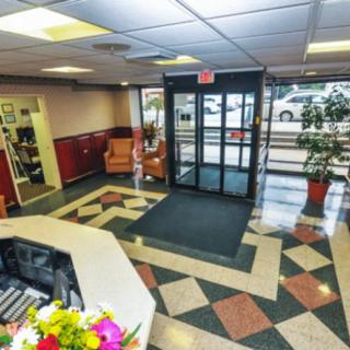 Modern lobby entrance with seating and decorative floor tiles.