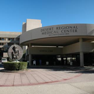 A view of the main entrance to a regional medical center featuring a sculpture.