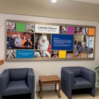 A welcoming waiting area featuring a photo collage on the wall, complemented by two comfortable chairs.