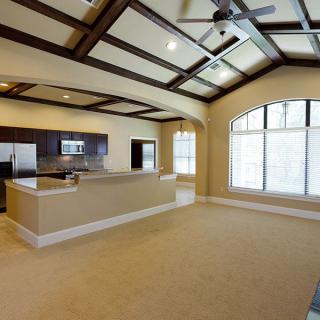 Spacious modern kitchen and living area with large windows and elegant design.
