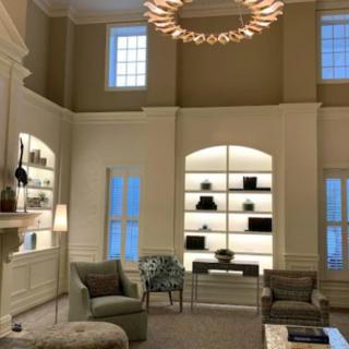 A luxurious living room with elegant furniture and a modern chandelier.