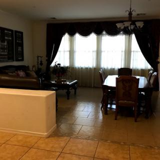 A cozy dining area and living space with large windows and elegant furnishings.