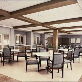A spacious and modern dining area featuring tables and chairs arranged for guests.