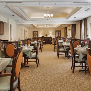 A spacious and elegant dining room with neatly arranged tables and chairs.