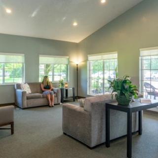 A bright and cozy living room with modern furnishings and large windows.