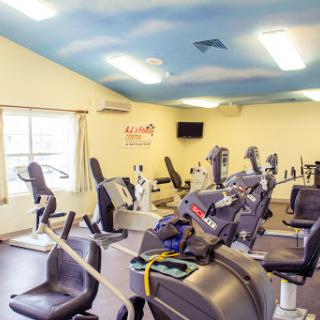 A well-equipped gym featuring various cardio machines for fitness enthusiasts.