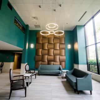 A stylish, modern lobby with contemporary furniture and unique lighting fixtures.
