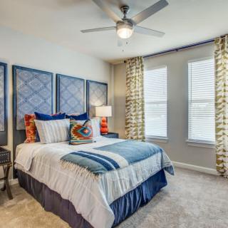A cozy bedroom with stylish decor and a comfortable bed.